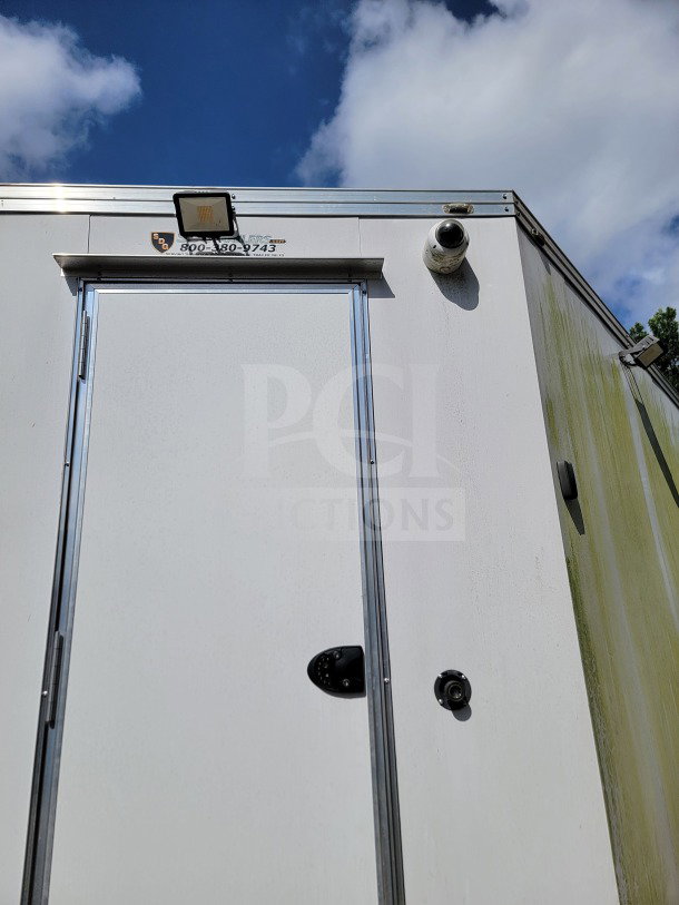 2021 SDG Model 26 trailer, white, security camera, mounted light, VIN 4S9S1EJ27MW364475, visible wear on exterior.