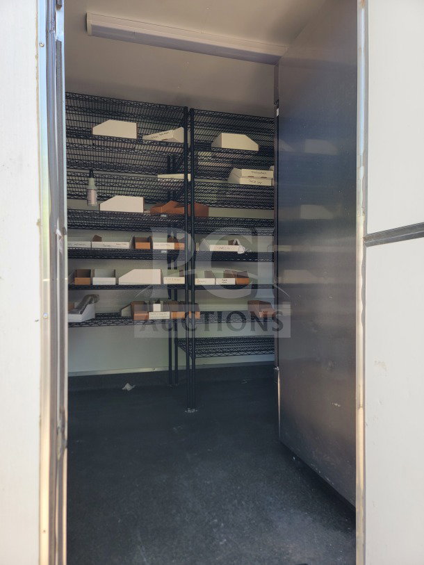 Interior view of LOT #13 SDG 26 trailer with metal shelving, part of 2021 model. Ideal for logistics/storage, in good condition.