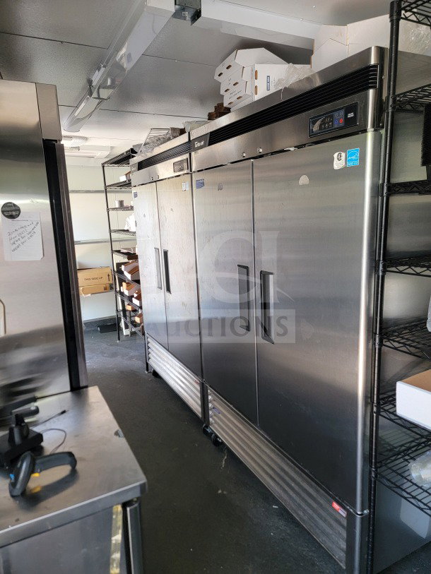 SDG 26: Interior view of a 2021 SDG 26' trailer with Turbo Air & Blueair refrigeration. Stainless steel units, shelves with boxes.