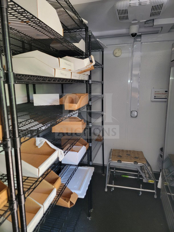 Inside view of SDG 26 tandem-axle trailer with wire shelving, Turbo Air unit, and Blueair refrigeration suite.