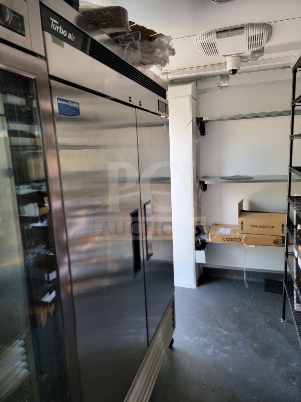 Interior view of a 2021 SDG logistics trailer featuring Turbo Air refrigeration, shelving, and storage space.