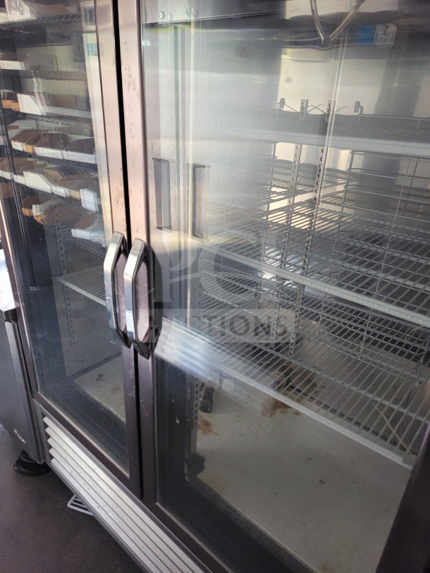 SDG Turbo Air refrigeration inside distribution trailer, glass door view, wire shelving, some visible wear, model 26.