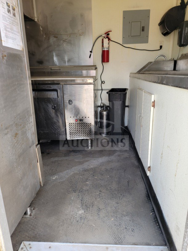 2019 Diamond Cargo 8.5' x 24' mobile kitchen trailer interior, featuring American Range suite, Serv-Ware fridge, and fire extinguisher.