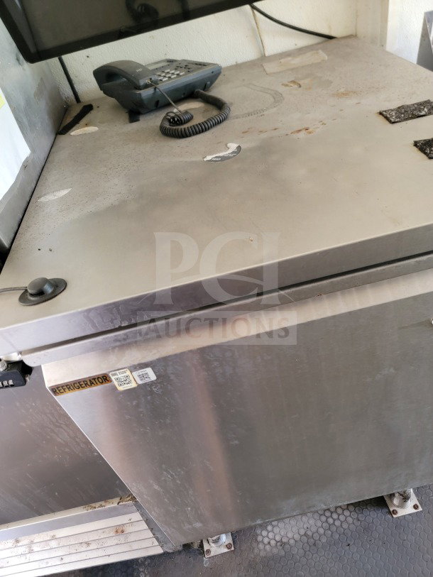 2019 Diamond Cargo mobile kitchen trailer interior showing a Serv-Ware refrigerator with visible wear and surface marks.