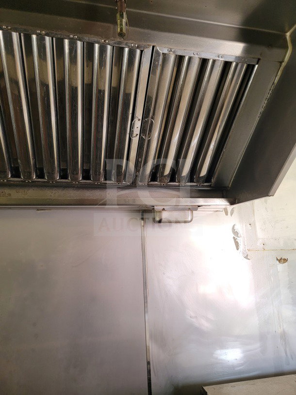 Stainless steel hood inside 2019 Diamond Cargo 8.5' x 24' mobile kitchen trailer. Features a professional-grade filter system.