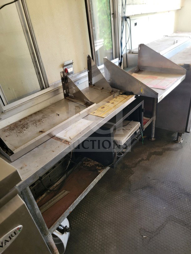 2019 Diamond Cargo 8.5' x 24' mobile kitchen trailer interior, showing stainless steel counters and equipment, moderate wear.