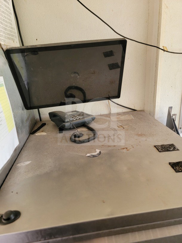 2019 Diamond Cargo 8.5' x 24' mobile kitchen trailer interior. Dusty counter with monitor and phone. Commercial food service setup.
