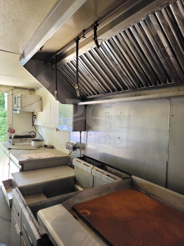 2019 Diamond Cargo 8.5' x 24' mobile kitchen trailer interior, featuring American Range cooking suite and Serv-Ware refrigeration in food service configuration.