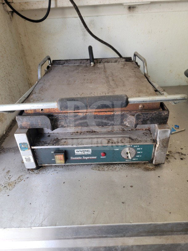 Waring Tostato Supremo commercial sandwich press on a metal countertop, showing wear; adjustable temperature dial; NSF certified.