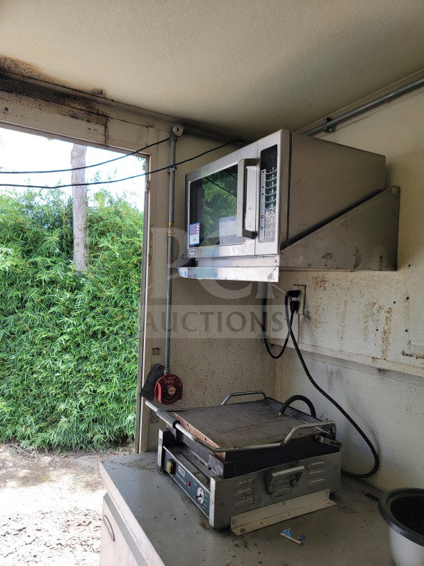 2019 Diamond Cargo mobile kitchen trailer interior with microwave and griddle. American Range cooking suite visible.