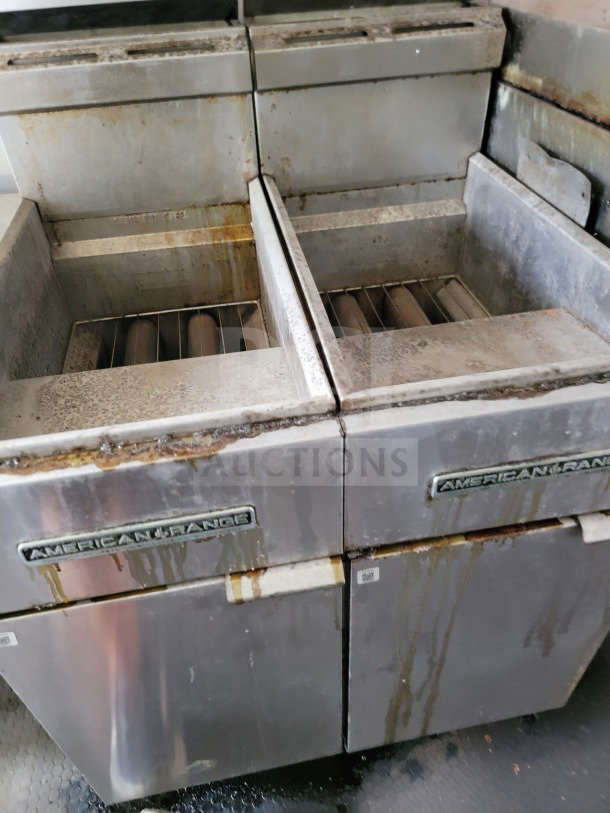American Range cooking suite in used condition, showing visible wear and rust. Stainless steel exterior with American Range logo.