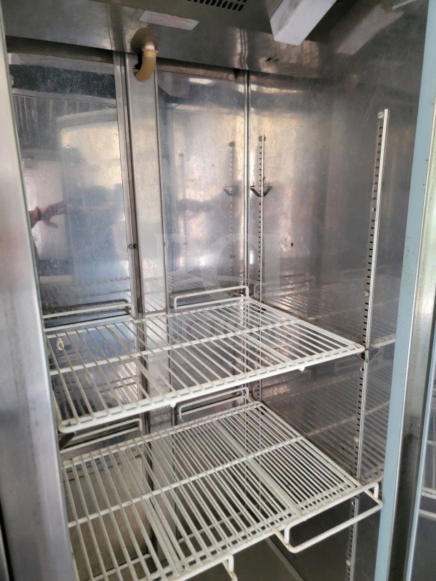 Interior of a commercial refrigeration unit in a 2019 Diamond Cargo mobile kitchen trailer, featuring wire shelving.