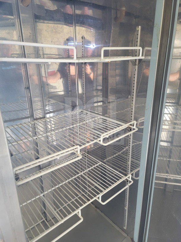 Interior view of a commercial Serv-Ware refrigeration unit with metal shelving inside a 2019 Diamond Cargo mobile kitchen trailer.