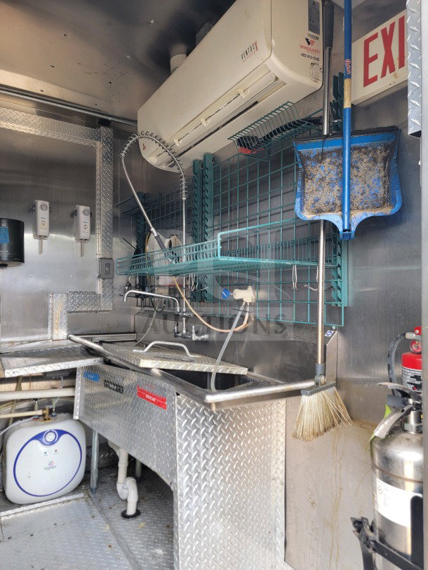 2021 BT&S 8.5' x 24' mobile kitchen trailer interior showing HVAC Mirage VentusX, sink, and cleaning supplies.
