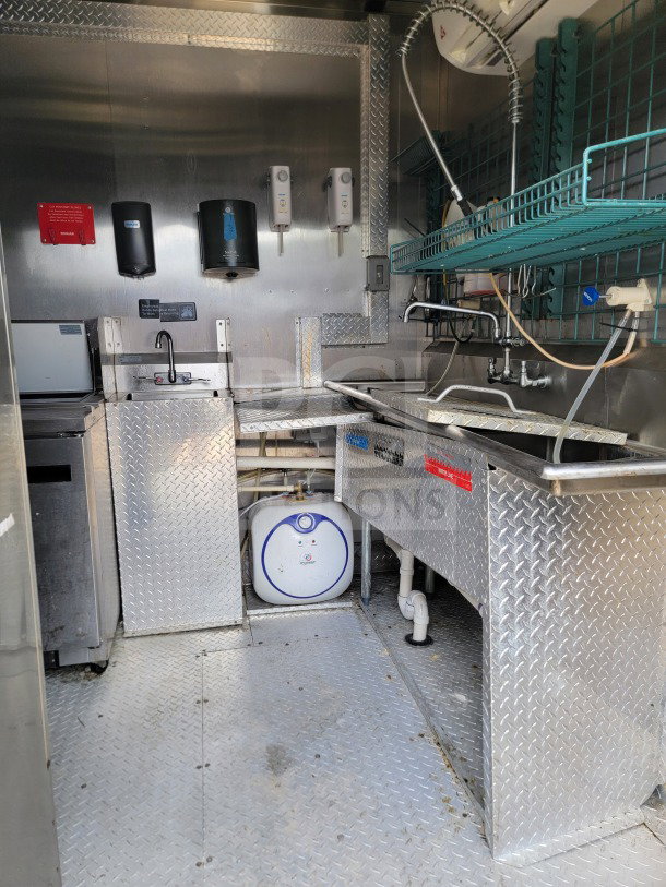 2021 BT&S 8.5'x24' mobile kitchen trailer interior. Features HVAC Mirage VentusX. Includes sink, dispensers, and diamond plate finish. VIN 1N9BE2428MD391107.
