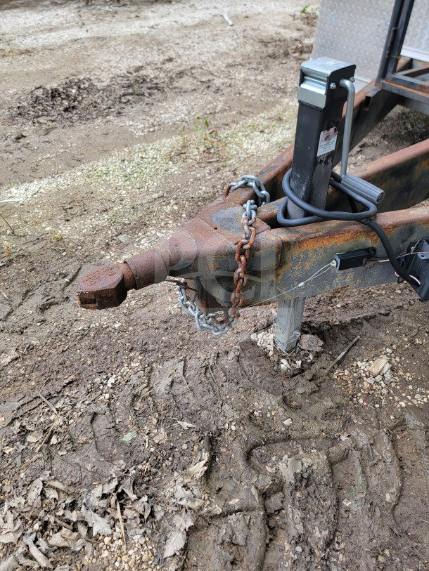 Close-up of a rusty hitch on a 2021 Best Trailers & Supply 8.5' x 24' mobile kitchen trailer. Chain and hitch details visible.