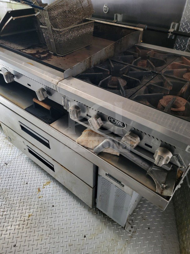 Royal commercial stove in a BT&S 8.5' x 24' mobile kitchen trailer. Features burners, grill, and fryer. Good condition.