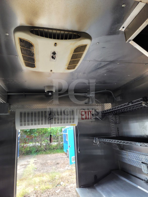 2021 BT&S 8.5' x 24' mobile kitchen trailer interior with HVAC Mirage VentusX, metal shelving, and exit signage.