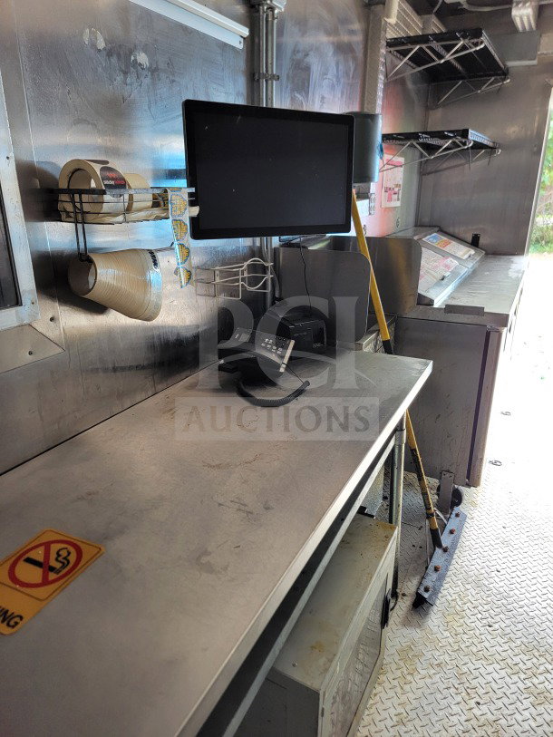 2021 BT&S 8.5' x 24' mobile kitchen trailer interior; features workspace, equipment, and shelving in used condition.