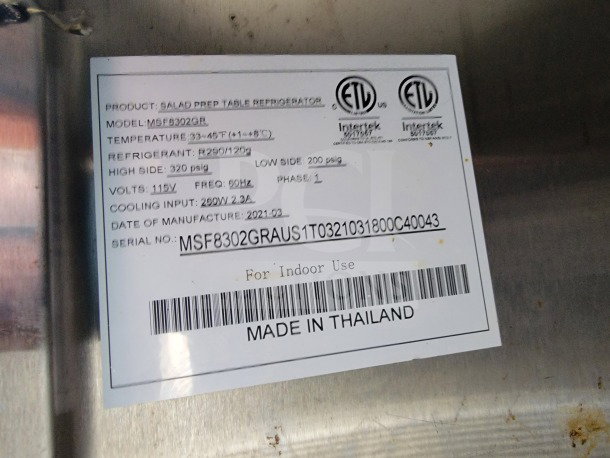 Label on stainless steel surface showing details of a Salad Prep Table Refrigerator. Model: MSF8302GR, temperature range 33-45°F, made in 2021.