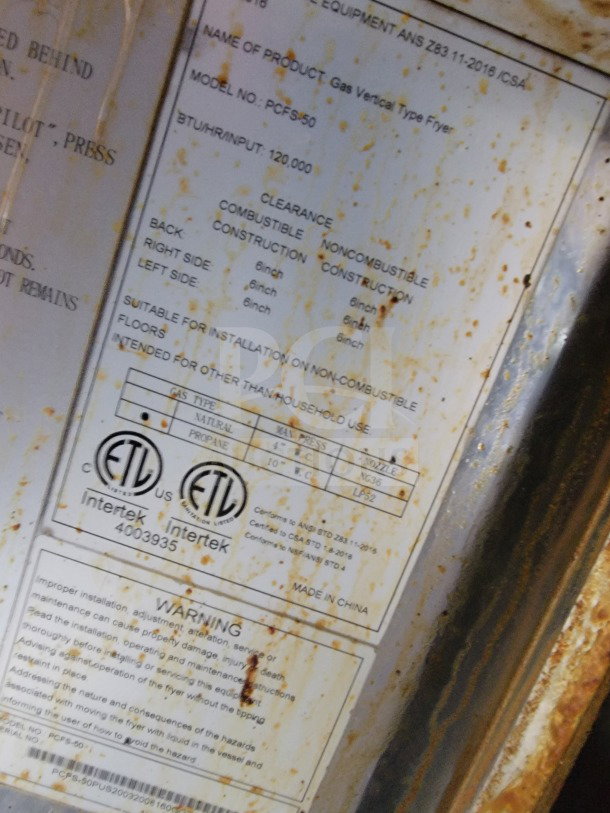 Rusty label on gas vertical fryer model PCFS-50. Indicates 120,000 BTU/hr, made in China. Includes safety warnings and ETL markings.