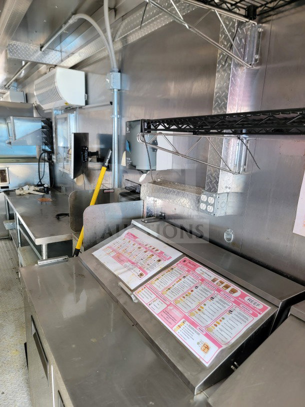 2021 Best Trailers & Supply 8.5' x 24' mobile kitchen trailer interior; stainless steel surfaces, HVAC Mirage VentusX, menu display.