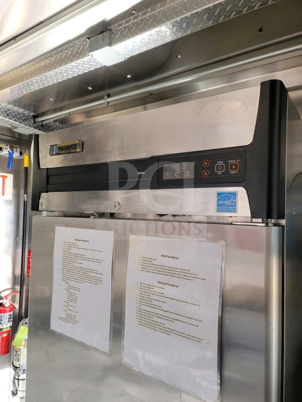 Stainless steel machinery fridge inside 2021 BT&S 8.5' x 24' mobile kitchen trailer. Energy Star label visible.