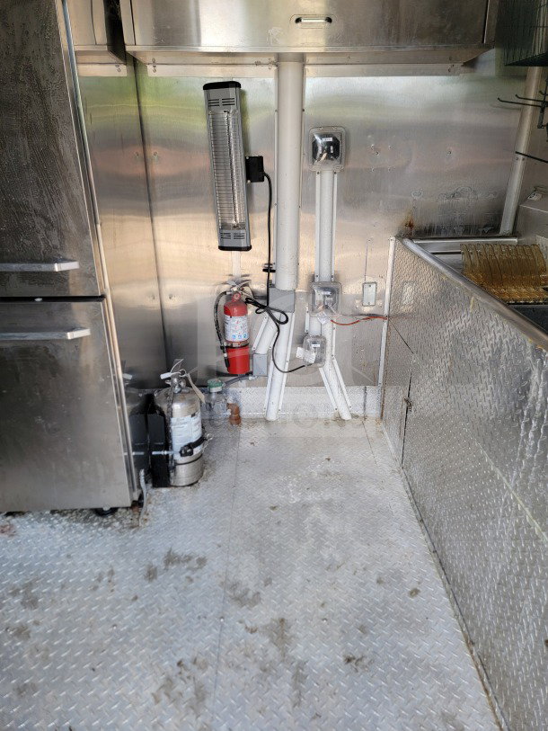 2021 Titanium Cargo 8.5' x 24' Mobile Kitchen Trailer interior, features stainless steel CaptiveAire hood, utility outlets, fryer.