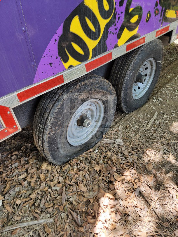 2021 Titanium Cargo 8.5' x 24' tandem-axle mobile kitchen trailer with visible flat tires and colorful graffiti design.