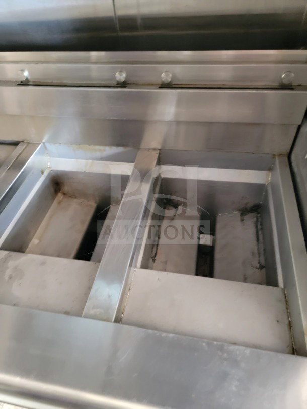 Interior view of a 2021 Titanium Cargo 8.5' x 24' mobile kitchen trailer, showcasing stainless steel equipment.