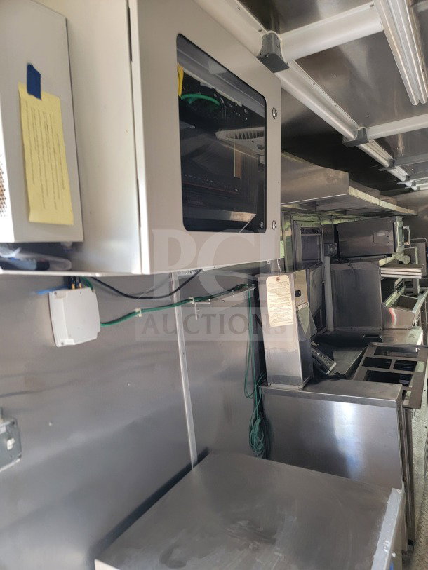 2021 Titanium Cargo 8.5' x 24' mobile kitchen trailer interior; features CaptiveAire hood, Randell, Frymaster appliances.