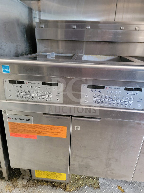 Frymaster suite in 2021 Titanium Cargo mobile kitchen trailer. Features control panels, door labels, used condition.