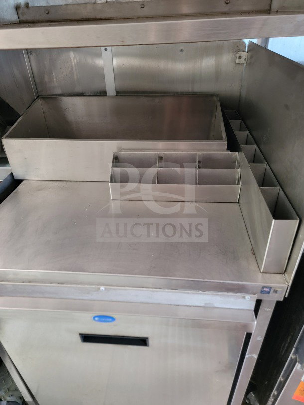 Stainless steel prep station with compartments in a 2021 Titanium Cargo 8.5' x 24' mobile kitchen trailer, visible CaptiveAire hood.