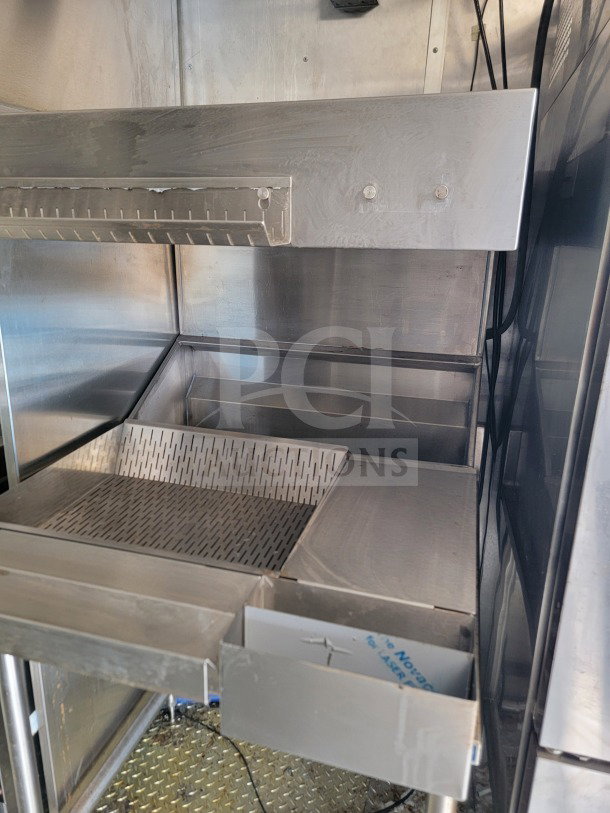 2021 Titanium Cargo 8.5' x 24' mobile kitchen trailer interior showing stainless steel fry station and storage drawers.