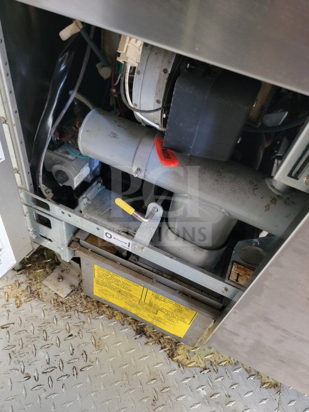 Interior view of 2021 Titanium 8.5' x 24' Mobile Kitchen Trailer mechanisms and wiring, featuring a manufacturer label and wiring details.