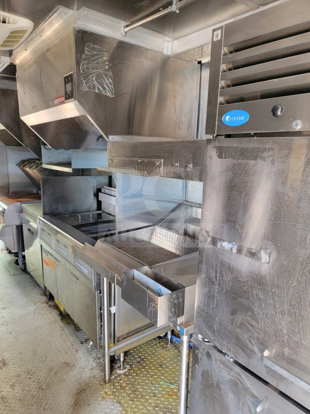 2021 Titanium Cargo 8.5' x 24' mobile kitchen trailer, equipped with CaptiveAire hood, Randell unit, and Frymaster suite.