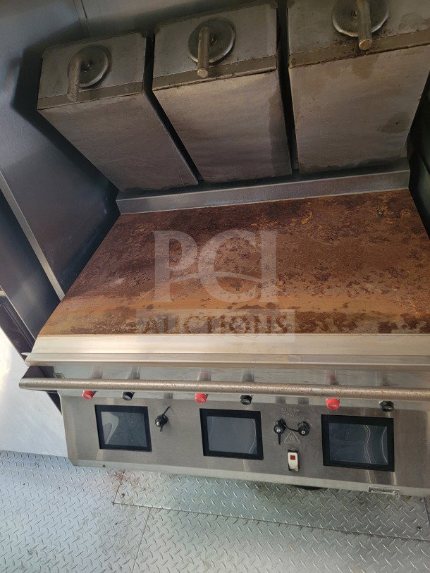 2021 Titanium Cargo mobile kitchen trailer interior featuring cooktop, control panel, and CaptiveAire hood in used condition.