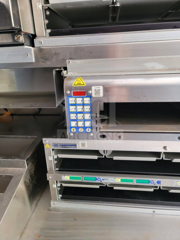 TITANIUM 24 mobile kitchen trailer interior featuring commercial kitchen equipment and control panels, in excellent condition.