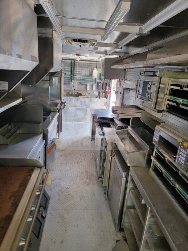 2021 Titanium Cargo 8.5' x 24' mobile kitchen trailer, features CaptiveAire hood, Randell & Frymaster suite, clean interior.