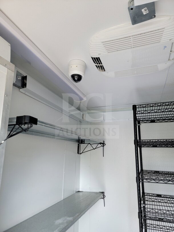 Interior of 2021 SDG 8.5' x 26' Mobile Kitchen Trailer, featuring shelves, ventilation, and security camera in excellent condition.