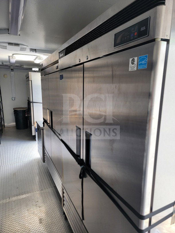 2021 SDG 8.5' x 26' mobile kitchen trailer interior with Turbo Air refrigeration, CaptiveAire hood, and diamond plate flooring.