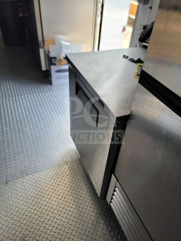 2021 SDG 8.5' x 26' mobile kitchen trailer interior; features Turbo Air refrigeration, diamond plate flooring.