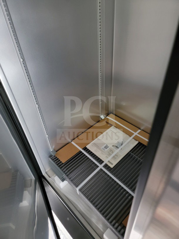 Interior of 2021 Southern Dimensions Mobile Kitchen Trailer. Features shelving and a visible document with details.