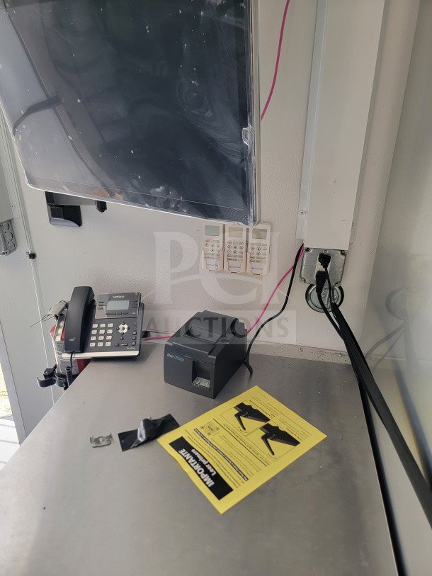 2021 SDG 26 Mobile Kitchen Trailer interior showing a phone, printer, and instruction sheet on a metal counter.