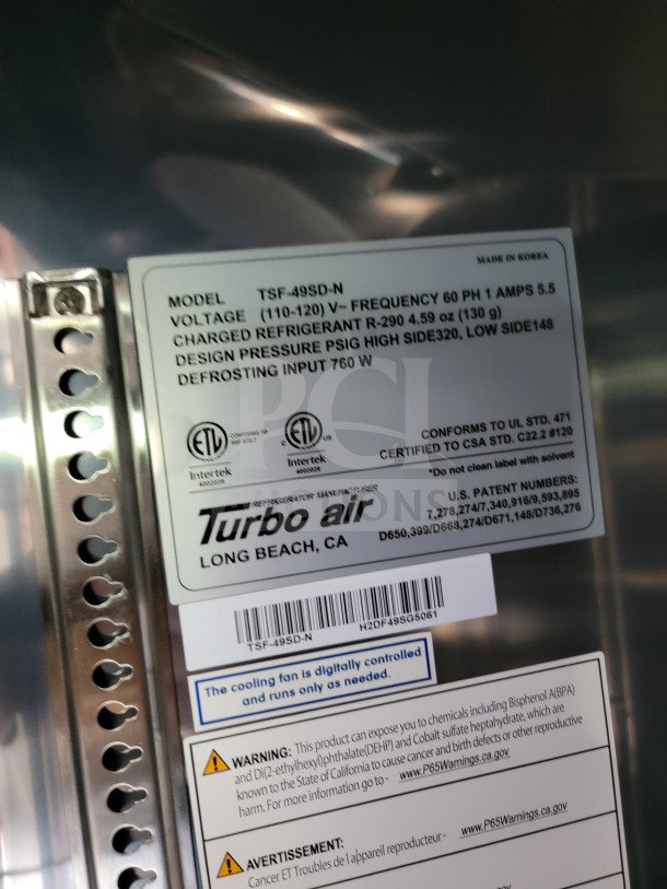 Turbo Air model TSF-49SD-N label. Details voltage, refrigerant charge, design pressure, and defrosting input. Safety warnings included.