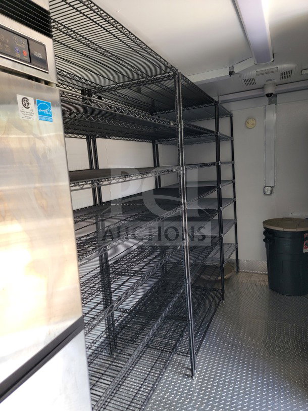 SDG Model 26 mobile kitchen trailer interior with steel shelves and CaptiveAire hood, Energy Star label visible, pristine condition.