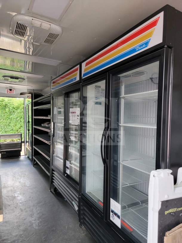 2021 SDG 8.5' x 20' mobile trailer interior with True freezers and shelves. Tandem-axle, 14,000 LB GVWR.