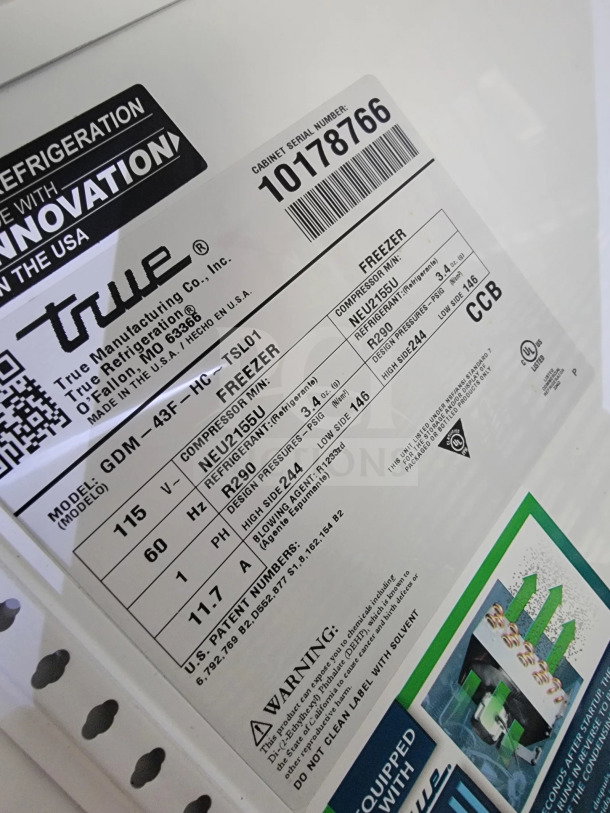 Label showing True Manufacturing freezer details, model GDM-43F-HC-TSL01, with specifications and warnings.