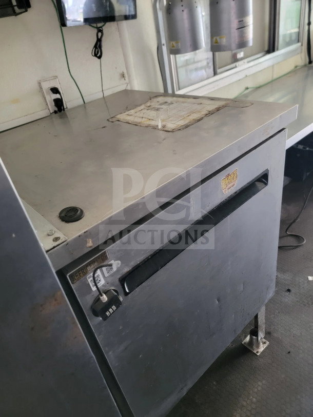 2019 Diamond Cargo mobile kitchen trailer featuring a stainless steel worktop, storage unit, and refrigeration system.