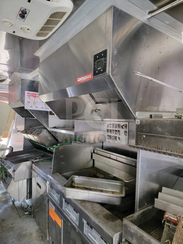 2021 Rock Solid Cargo 8.5' x 24' mobile kitchen trailer interior with CaptiveAire hood, used condition.